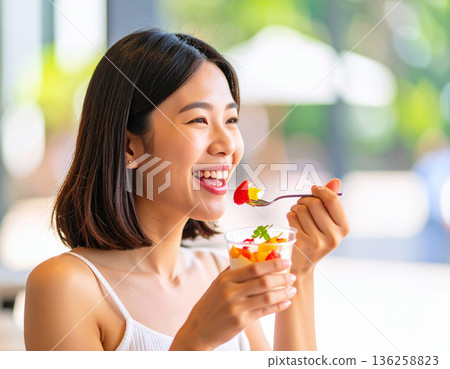 Young woman eating dessert 136258823