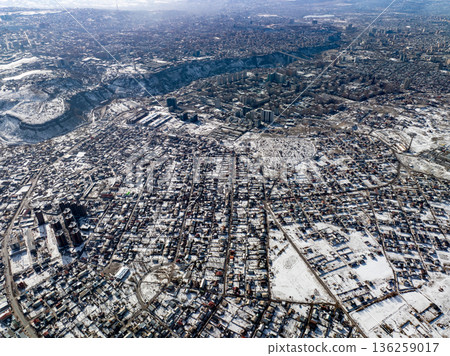 Aerial drone shot of a snow covered town with grid street layout Aerial drone shot of a snow covered town with grid street layout 136259017