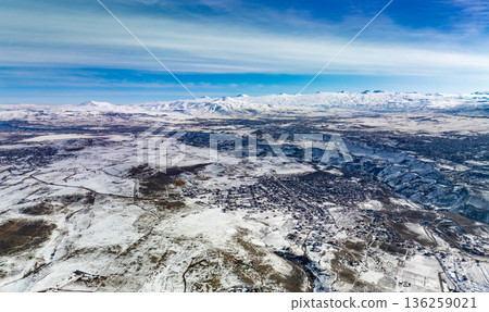 A snowy landscape with a blue sky in the background 136259021