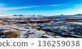 A snowy landscape with mountains in the background 136259038