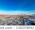 A snowy landscape with a city in the distance 136259042