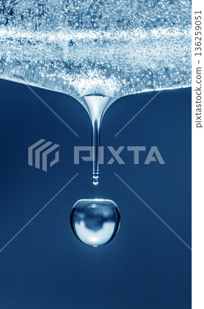 A drop of water is falling from a ice A drop of water is falling from a ice 136259051