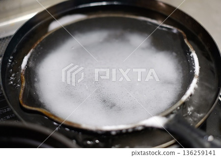 Removing burnt food from a skillet 136259141