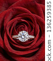 A beautiful rose with a diamond ring on top of it 136259385