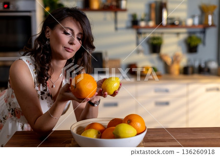Woman with curly hair in floral attire enjoying morning sunlight, Cheerful woman with curly hair and floral dress captures joyful morning moments near citrus fruits Woman with curly hair in floral attire enjoying morning sunlight, Cheerful woman with curly hair and floral dress captures joyful morning moments near citrus fruits 136260918