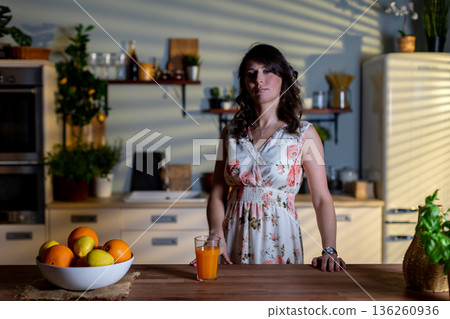 Woman cooking breakfast, Morning scene of woman with fresh citrus and warm rays, Woman in her kitchen arranging oranges with sunlight creating peaceful morning ambiance Woman cooking breakfast, Morning scene of woman with fresh citrus and warm rays, Woman in her kitchen arranging oranges with sunlight creating peaceful morning ambiance 136260936