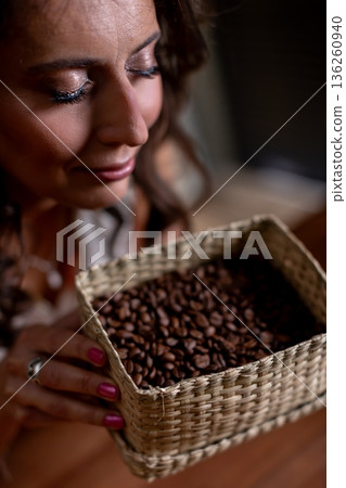 Calm smiling woman, Peaceful lady holding beans gently, Relaxed woman with basket and soft expression, Serene female figure with beans beneath gentle shadow lighting Calm smiling woman, Peaceful lady holding beans gently, Relaxed woman with basket and soft expression, Serene female figure with beans beneath gentle shadow lighting 136260940