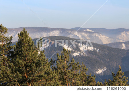 Winter landscape from top view of krasnoyarsk pillars national park mountains. Pine forest with snow on hills ideal for travel and tourism 136261000