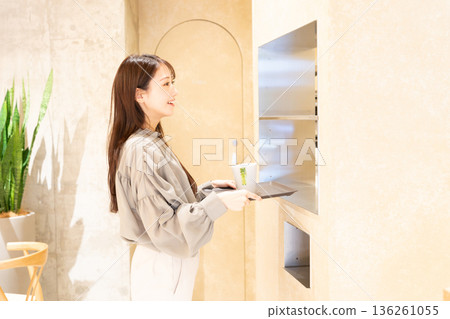Young woman returning a car at a self-service cafe 136261055