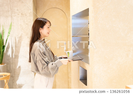 Young woman returning a car at a self-service cafe 136261056