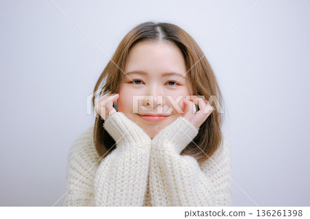 Woman in white knit Woman in white knit 136261398
