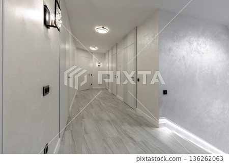 Modern minimalist hallway with white hidden doors and elegant lighting 136262063