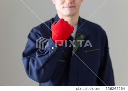 Middle-aged male businessman in work clothes making a fist pump 136262264