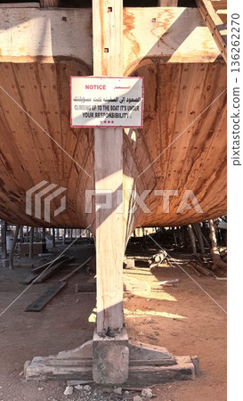 Restoration Specialist Inspects Weathered Wooden Ship Structure And Repairs. Shipyard Worker Meticulously Assesses Aged Timber And Metal Components During Preservation Process Restoration Specialist Inspects Weathered Wooden Ship Structure And Repairs. Shipyard Worker Meticulously Assesses Aged Timber And Metal Components During Preservation Process 136262270