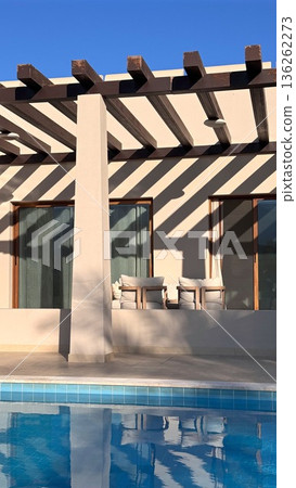 Bright Tranquil Retreat. Sundrenched Outdoor Structure Showcasing Calm Reflective Surfaces And Modern Minimalist Architectural Style For Peaceful Vacation Atmosphere 136262273