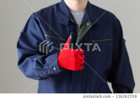 Middle-aged male businessman in work clothes making a fist pump Middle-aged male businessman in work clothes making a fist pump 136262359
