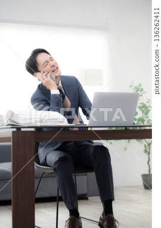 A man in a suit, worried and in a hurry, is urging the president or manager to collect accounts receivable at the end of the month. A man in a suit, worried and in a hurry, is urging the president or manager to collect accounts receivable at the end of the month. 136262411