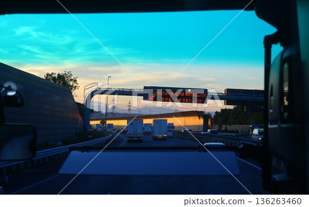 A view of the highway at dusk from the bus window A view of the highway at dusk from the bus window 136263460
