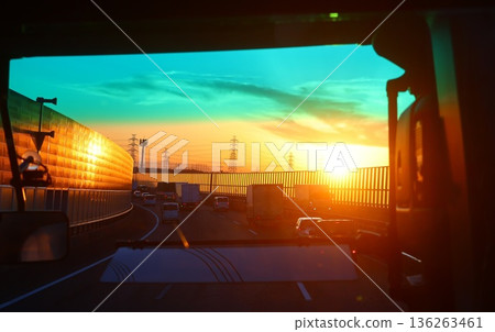 A beautiful sunset seen from the bus window on the highway 136263461