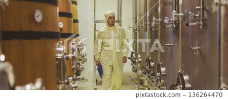 Winemaker working in modern large winery factory liquor drink industry quality. Winemaker working in modern large winery factory liquor drink industry quality. 136264470