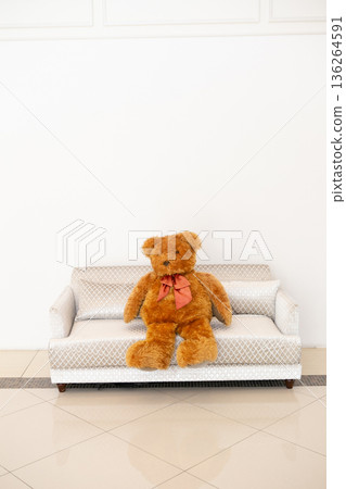 teddy bear sitting on the sofa 136264591