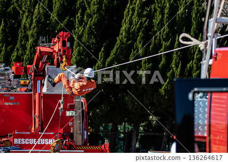 Ranger firefighters walk across a rope during a rescue demonstration at the New Year's rescue ceremony. 136264617
