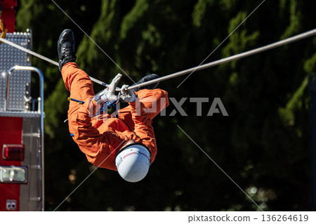 Ranger firefighters walk across a rope during a rescue demonstration at the New Year's rescue ceremony. Ranger firefighters walk across a rope during a rescue demonstration at the New Year's rescue ceremony. 136264619