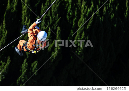 Ranger firefighters walk across a rope during a rescue demonstration at the New Year's rescue ceremony. Ranger firefighters walk across a rope during a rescue demonstration at the New Year's rescue ceremony. 136264625