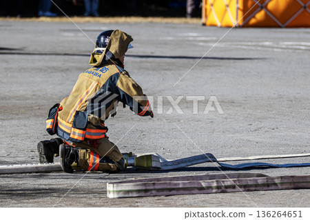 Firefighters prepare hoses for a water-spraying demonstration at the New Year's ceremony Firefighters prepare hoses for a water-spraying demonstration at the New Year's ceremony 136264651