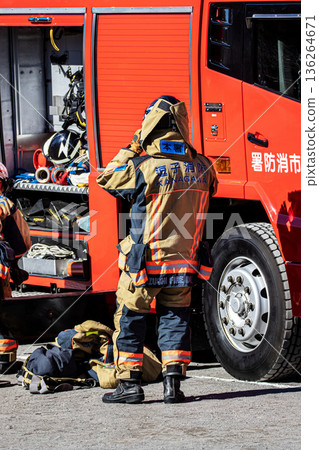 Firefighters prepare next to a fire engine to demonstrate firefighting training at the New Year's ceremony Firefighters prepare next to a fire engine to demonstrate firefighting training at the New Year's ceremony 136264671