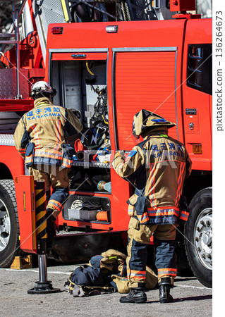 Firefighters prepare next to a fire engine to demonstrate firefighting training at the New Year's ceremony 136264673