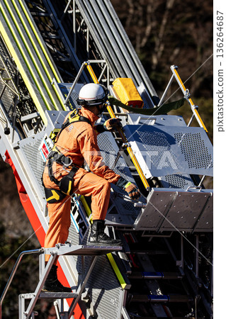 Firefighters extend the ladder of a fire engine and demonstrate rescue operations at the New Year's ceremony 136264687