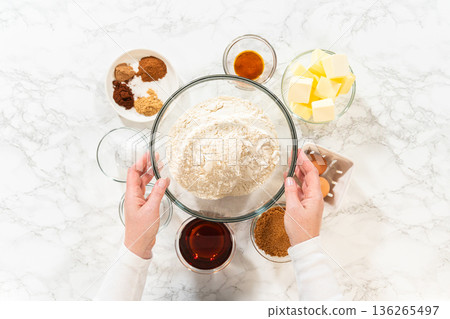 Top view of ingredients for Amber Gingerbread Cookie Dough, including flour, butter, eggs, brown sugar, molasses, and various spices, arranged on a marble surface. Top view of ingredients for Amber Gingerbread Cookie Dough, including flour, butter, eggs, brown sugar, molasses, and various spices, arranged on a marble surface. 136265497