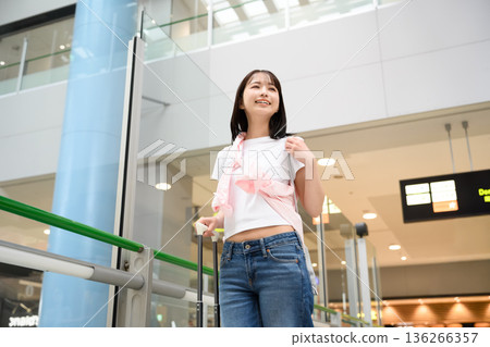 A woman enjoying her trip at the airport. Photo courtesy of Kansai International Airport (KIX) 136266357