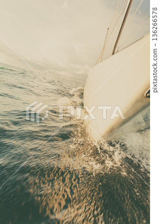 Yachting on sail boat bow stern shot splashing water Yachting on sail boat bow stern shot splashing water 136266578