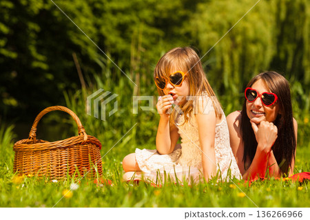 Mother and daughter on picnic. Summer leisure. 136266966