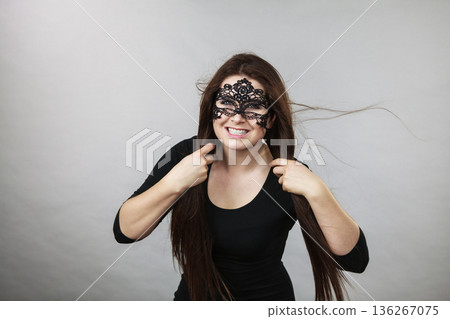 Mysterious woman wearing lace mask 136267075