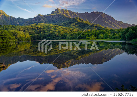 View of the Togakushi mountain range at sunrise from Kagami Pond View of the Togakushi mountain range at sunrise from Kagami Pond 136267732
