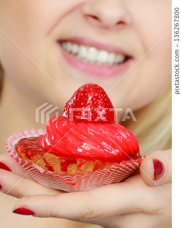 Woman holding sweet delicious cupcake Woman holding sweet delicious cupcake 136267800