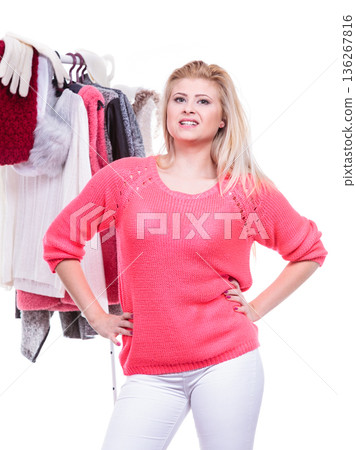 Woman in home closet choosing clothing, indecision 136267816