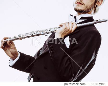 Male flutist wearing tailcoat holds flute Male flutist wearing tailcoat holds flute 136267983