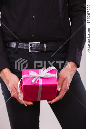 man holding present pink gift box in hands 136267992