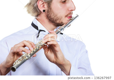 Male flutist playing his flute Male flutist playing his flute 136267997