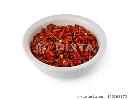 Dried red chili flakes in white bowl on white background 136268173