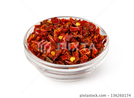 Dried red chopped chili pepper flakes in glass bowl Dried red chopped chili pepper flakes in glass bowl 136268174