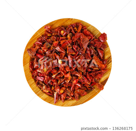 Dried red chili flakes in wooden bowl 136268175