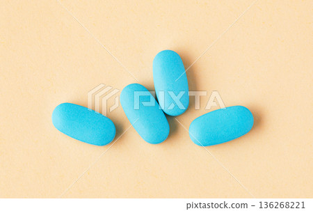 Blue oblong pills on a light background Blue oblong pills on a light background 136268221