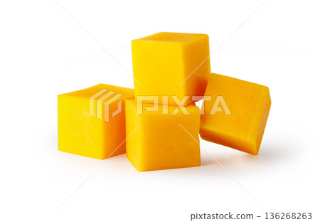 Five yellow cheddar cheese cubes on white background 136268263