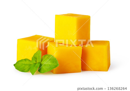 Yellow cheddar cheese cubes with fresh basil leaf 136268264