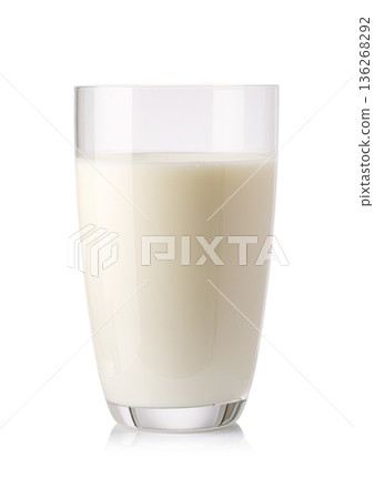 Glass of white milk reflecting on white surface Glass of white milk reflecting on white surface 136268292